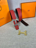 Red and black belt with silver H buckle and gold H buckle piece
