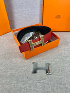 Red and black belt in box with silver engraved H buckle and clasp pieces