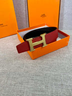 Red leather belt with gold H buckle in orange gift box
