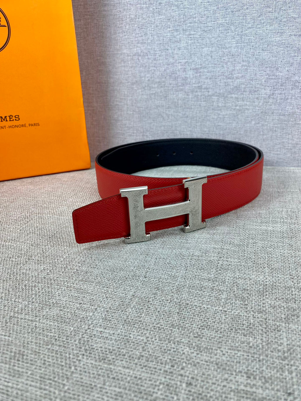 Red leather belt with silver H buckle and black lining