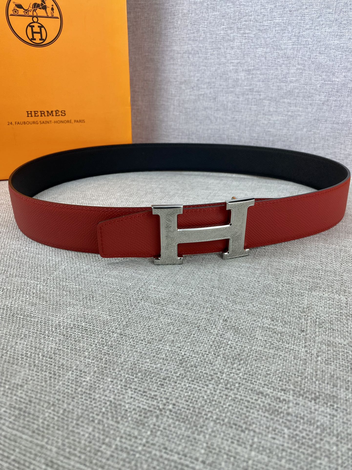 Red and black leather belt with silver H buckle