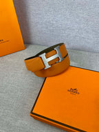 Orange leather belt with silver H buckle and olive keeper strap
