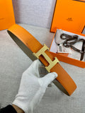 Orange leather belt with gold H buckle and olive-green keeper strap