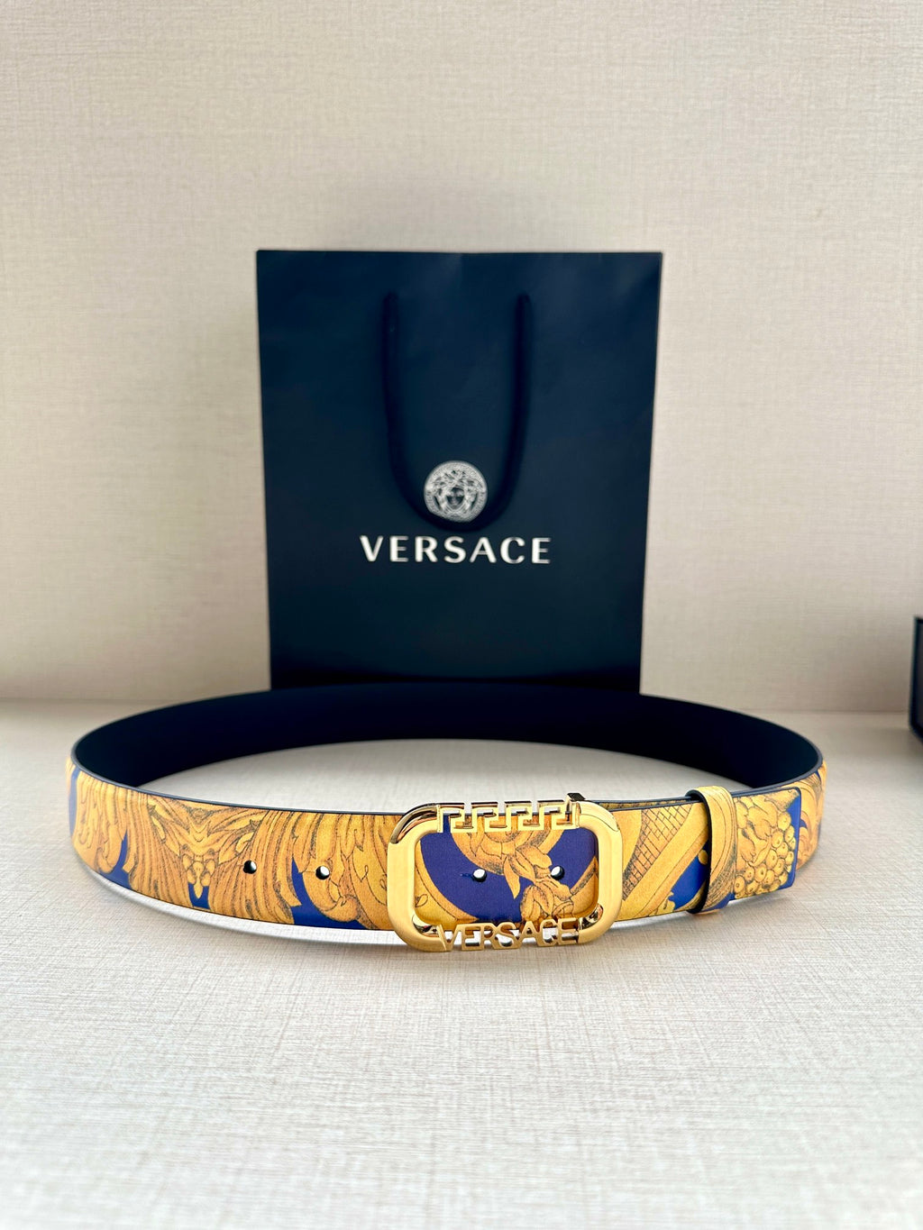 Versace belt with blue and gold baroque pattern, gold-tone buckle, medium width.