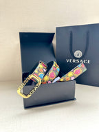 Versace belt in gift box, showing multicolor printed strap and gold-tone buckle
