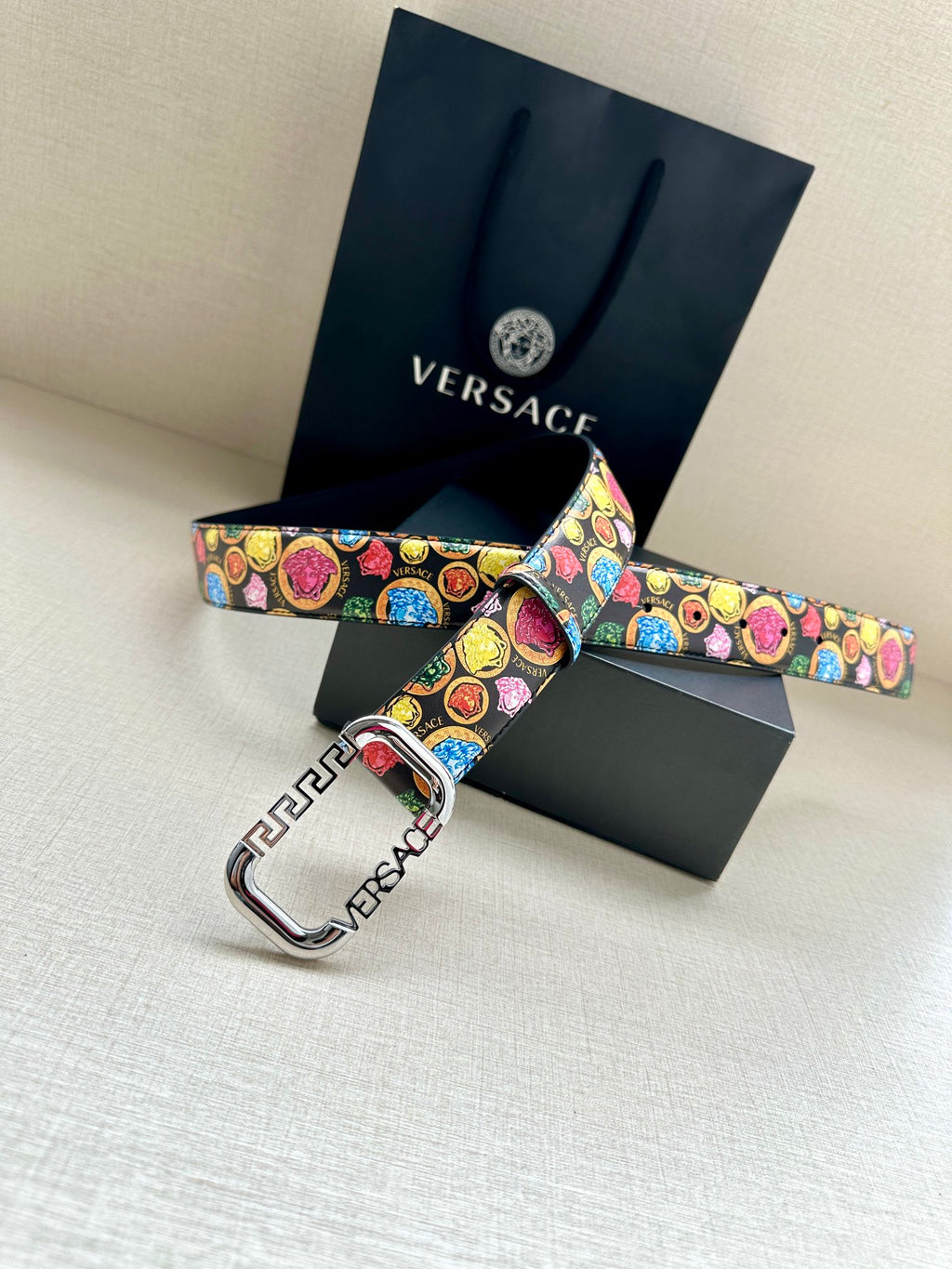Versace belt with multicolor medallion print and silver-tone buckle on a dark strap