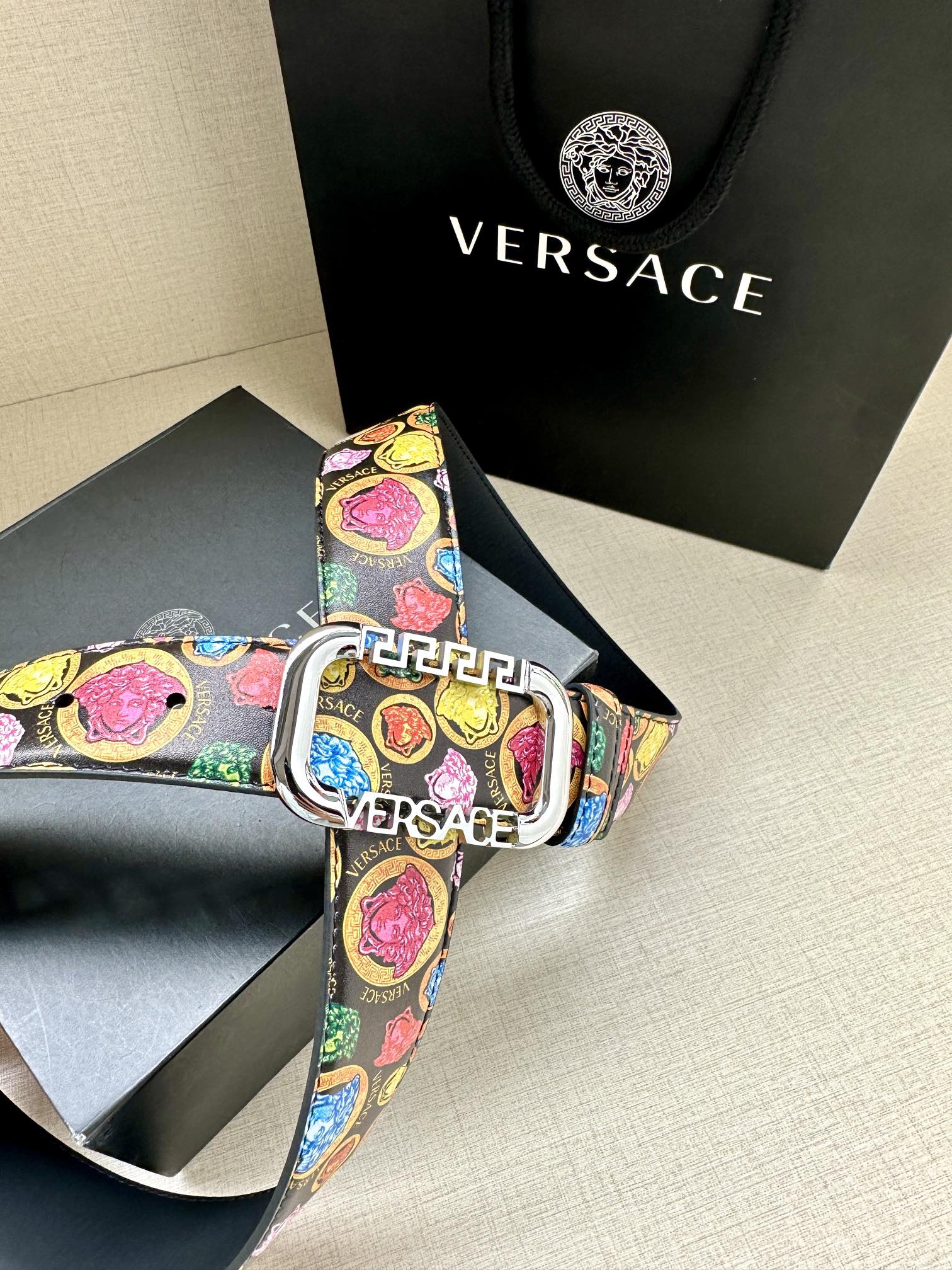 Versace belt buckle close-up with multicolor print and Versace branding on the strap