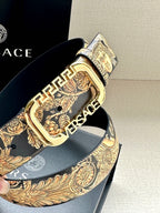 Versace belt detail with gold-toned buckle over gold baroque patterned strap