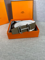 Hermes belt with olive outer strap and white underside, gold buckle centered