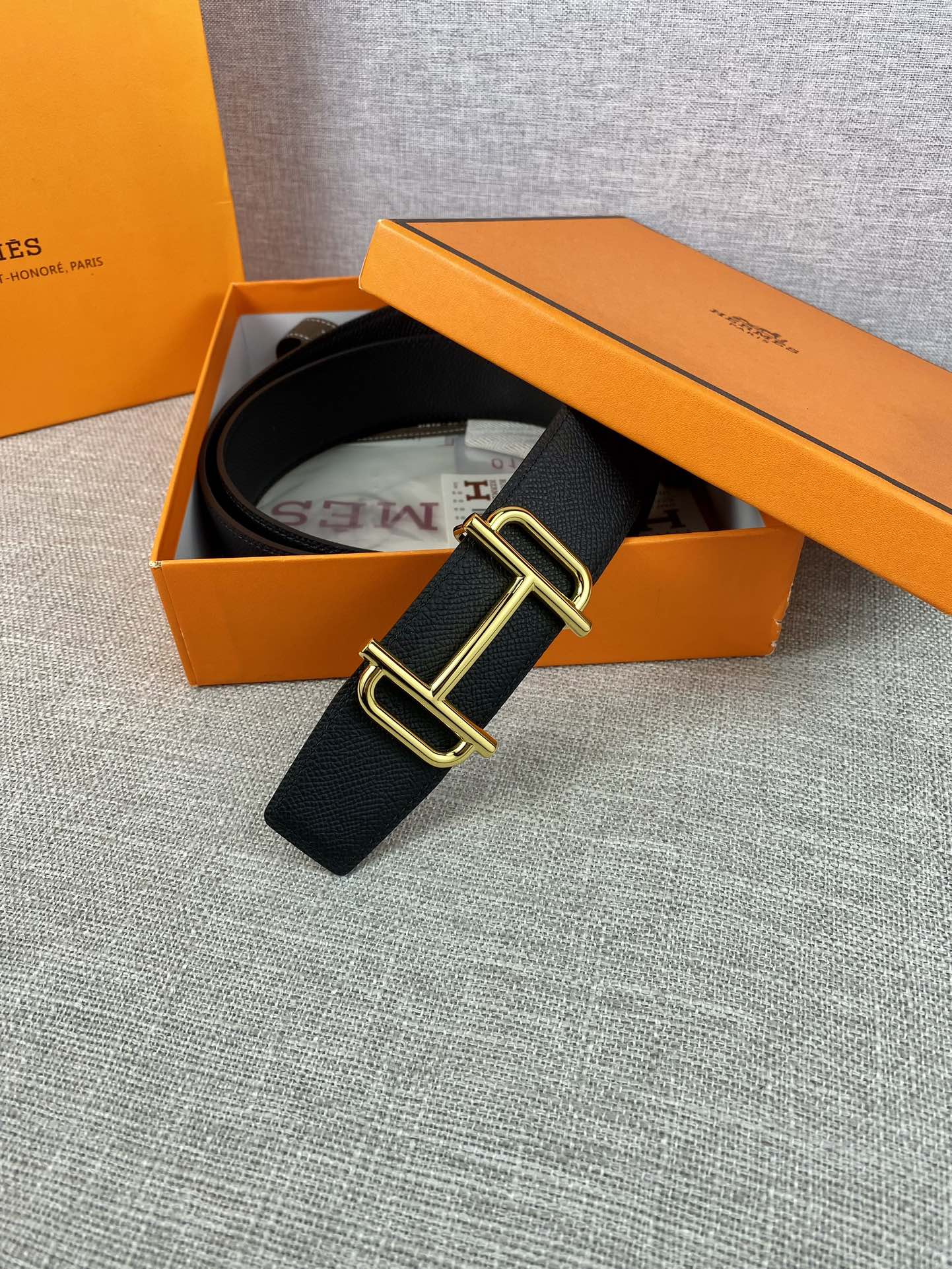 Hermes belt with dark textured leather and gold-tone double-prong buckle