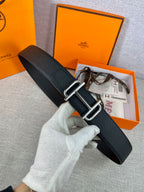 Hermes belt with dark textured leather and silver double-prong buckle, adjustable holes