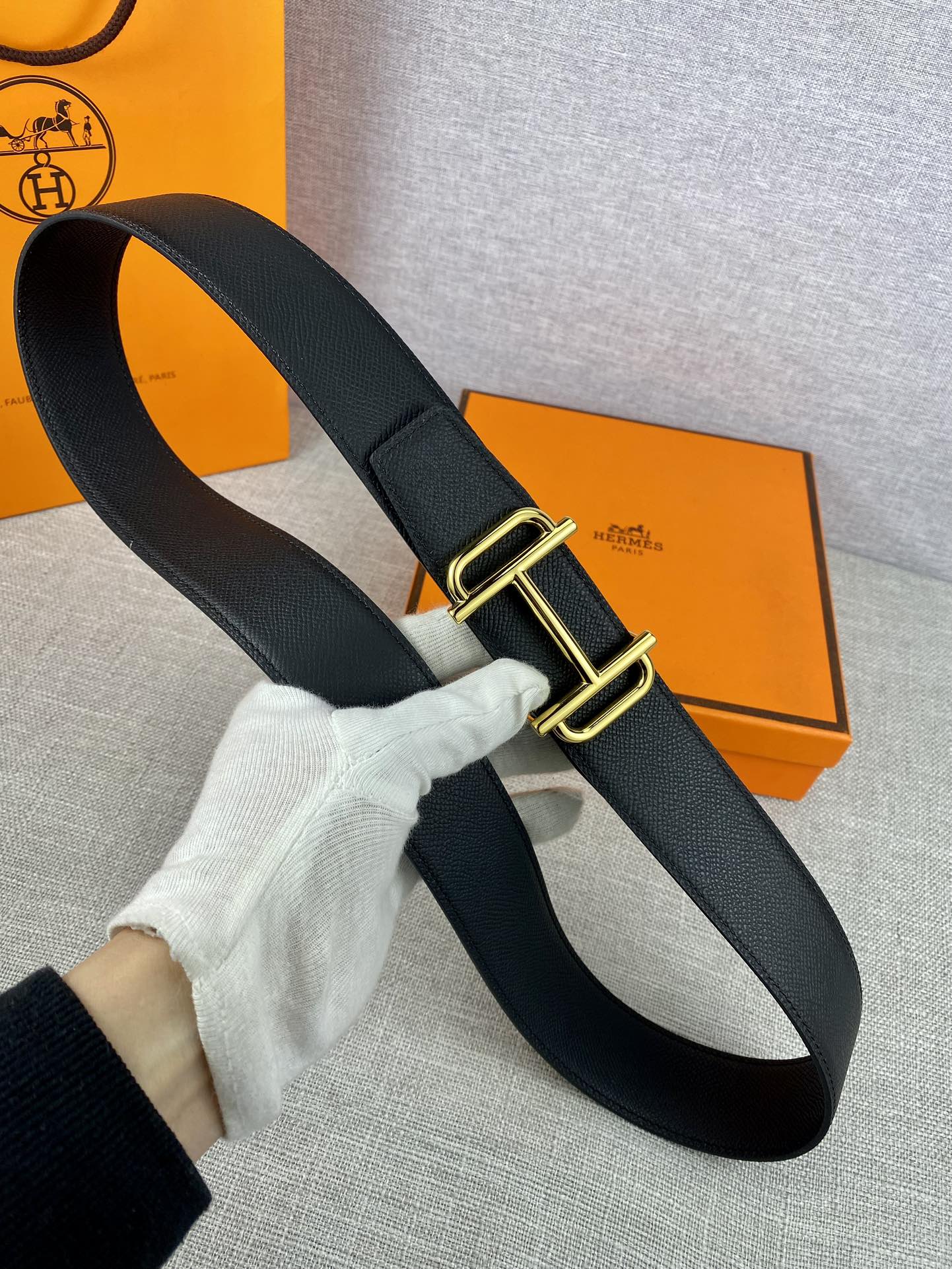 Hermes belt with gold-tone buckle and dark textured leather strap
