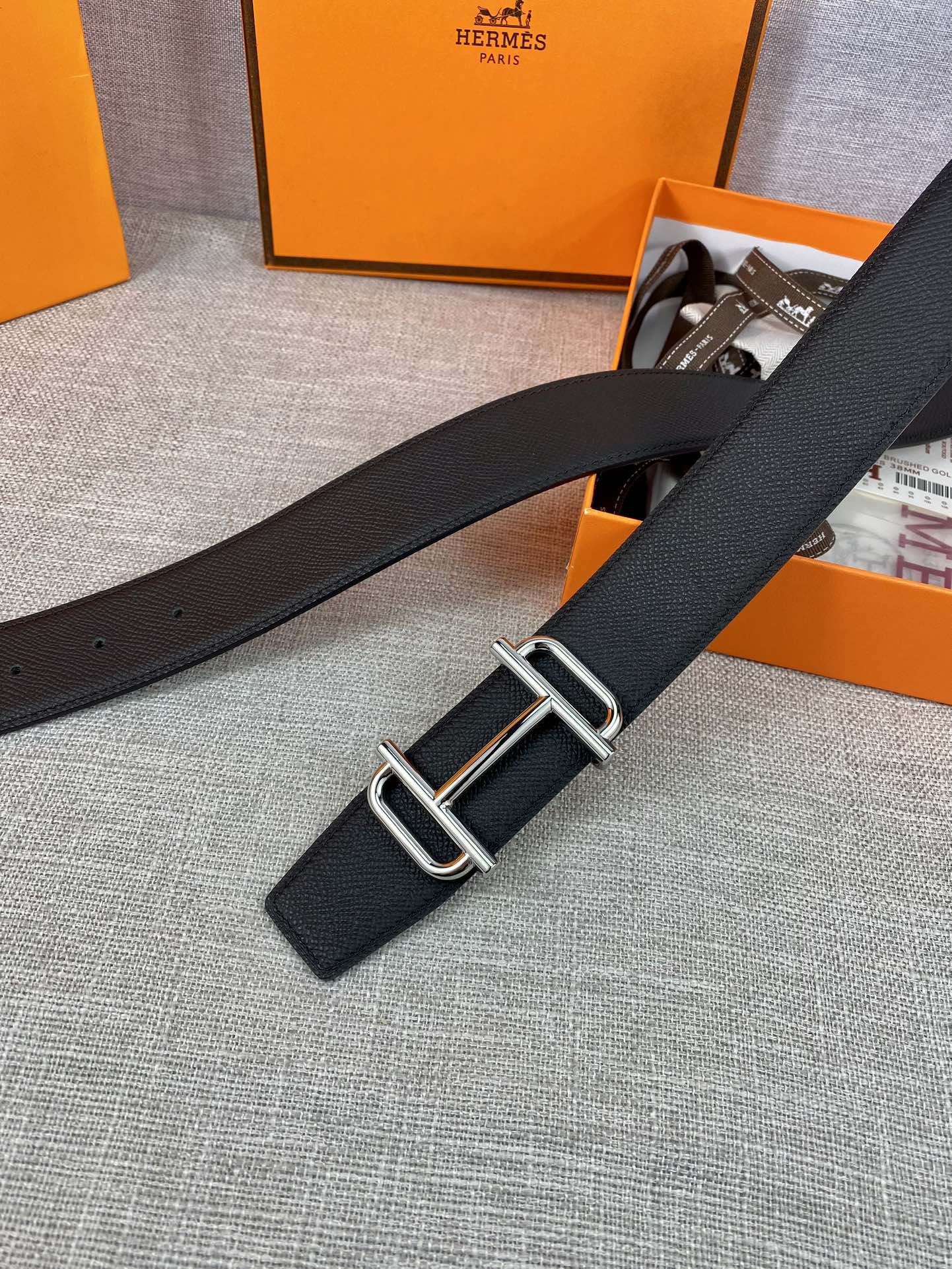 Hermes belt with dark textured leather strap and silver double-prong buckle