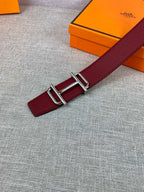 Burgundy leather belt detail with metallic rectangular buckle hardware