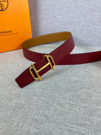 Burgundy leather belt with gold-tone buckle and tan underside