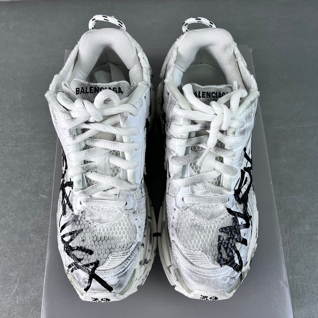 Unisex white sneakers with BALENCIAGA on heel, black graffiti-style side marks
