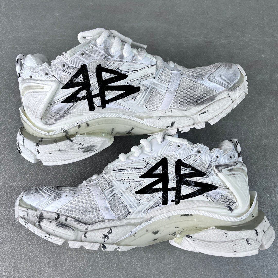 Unisex white sneakers with black graffiti-style print, lace-up, thick midsole