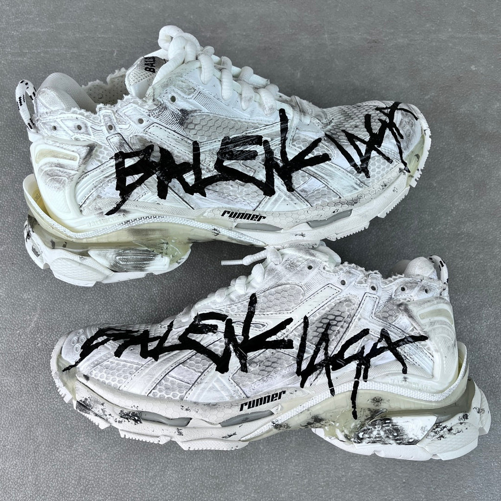 Unisex white sneakers with black graffiti-style print, lace-up, chunky sole