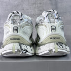 Unisex white sneakers showing heel branding and black graffiti-style side accents