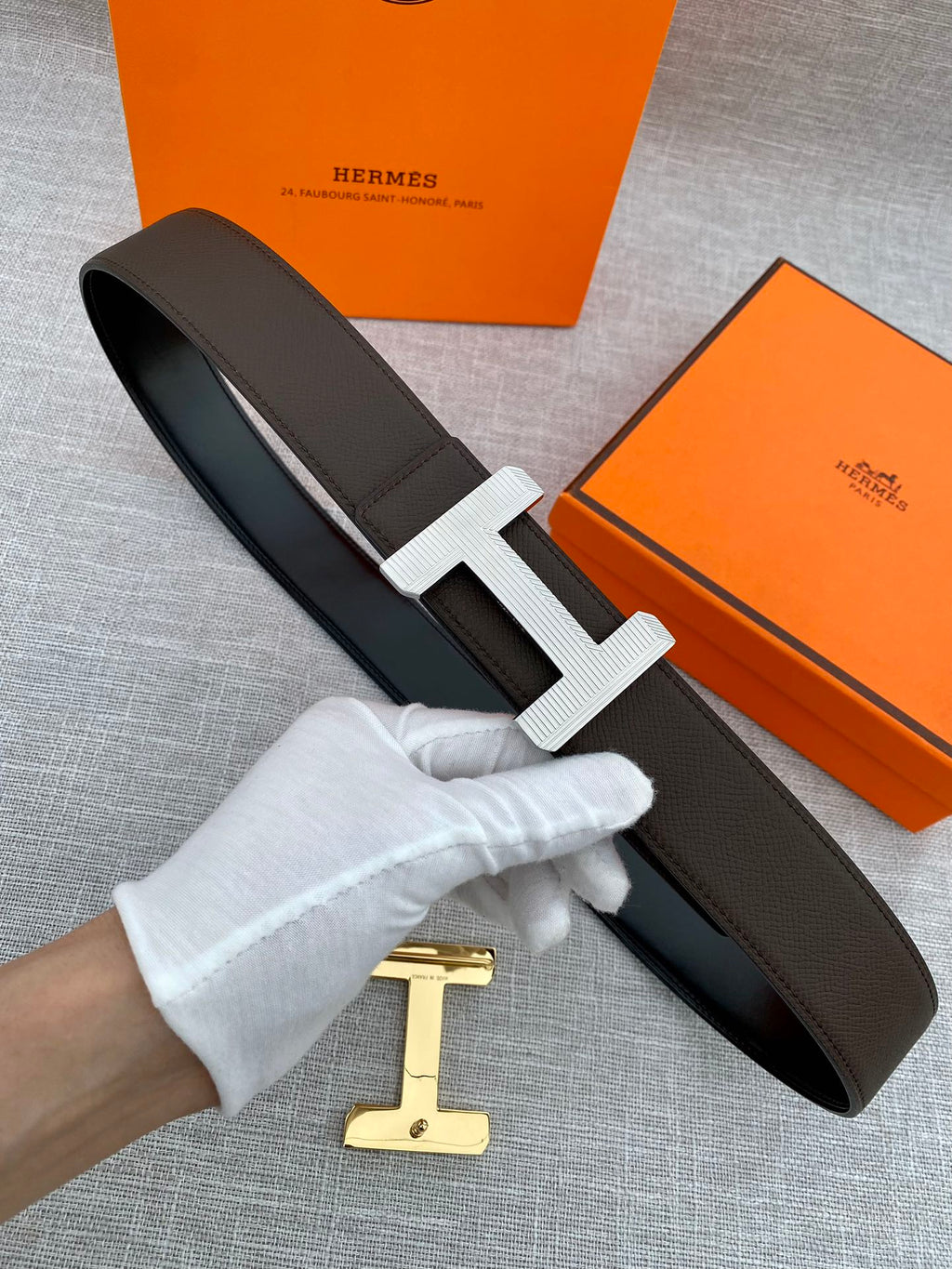 Hermes belt with dark leather strap and silver-tone H buckle