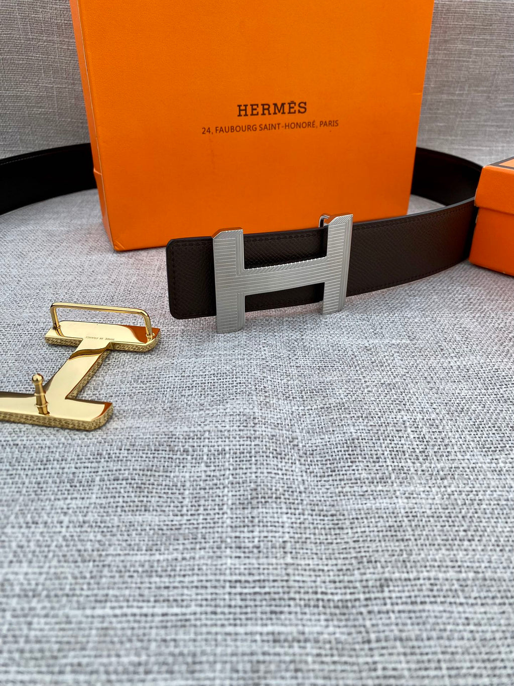 Hermes belt with dark leather strap and gold-tone H buckle