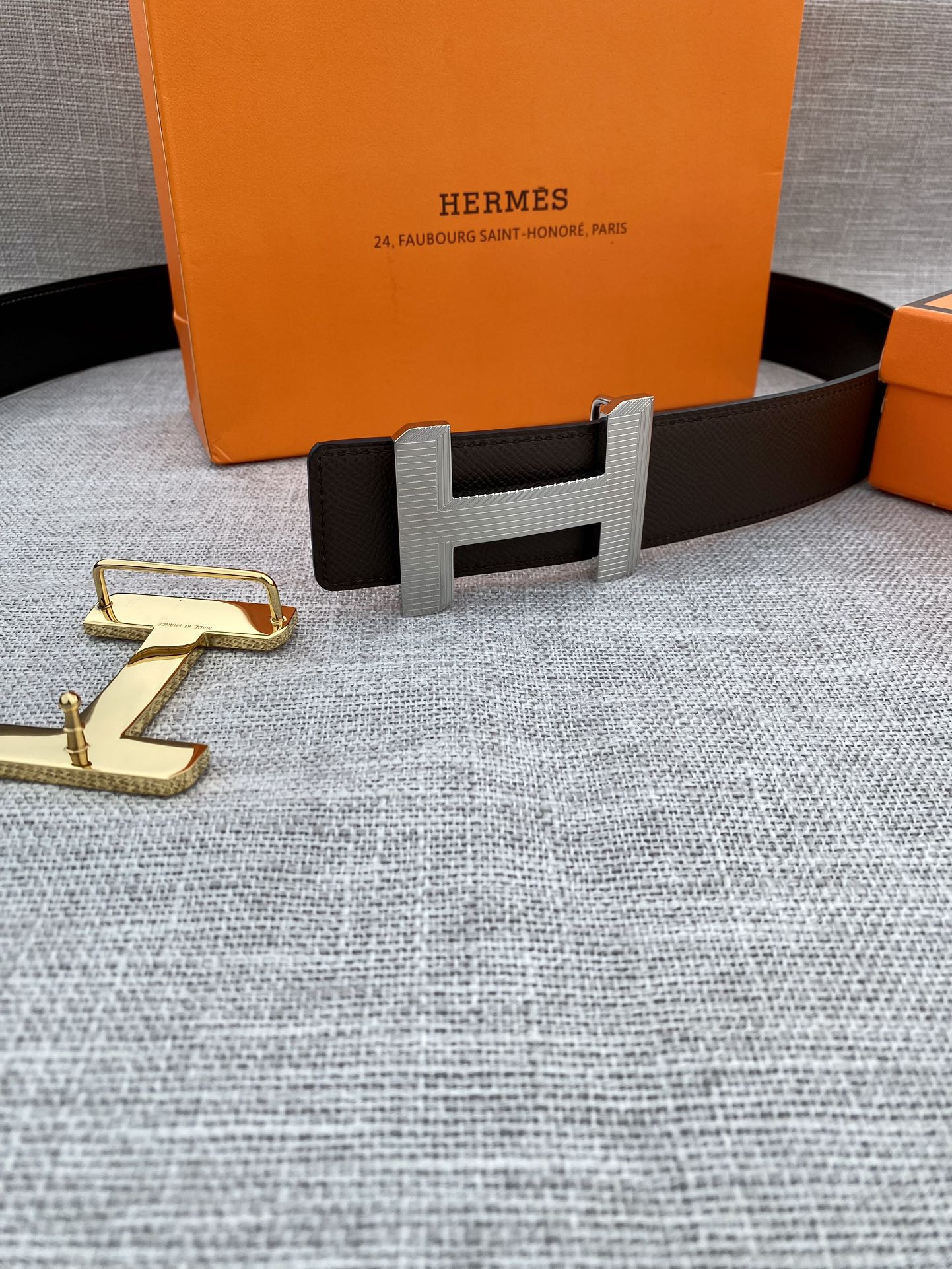 Hermes belt with dark leather strap and gold-tone H buckle