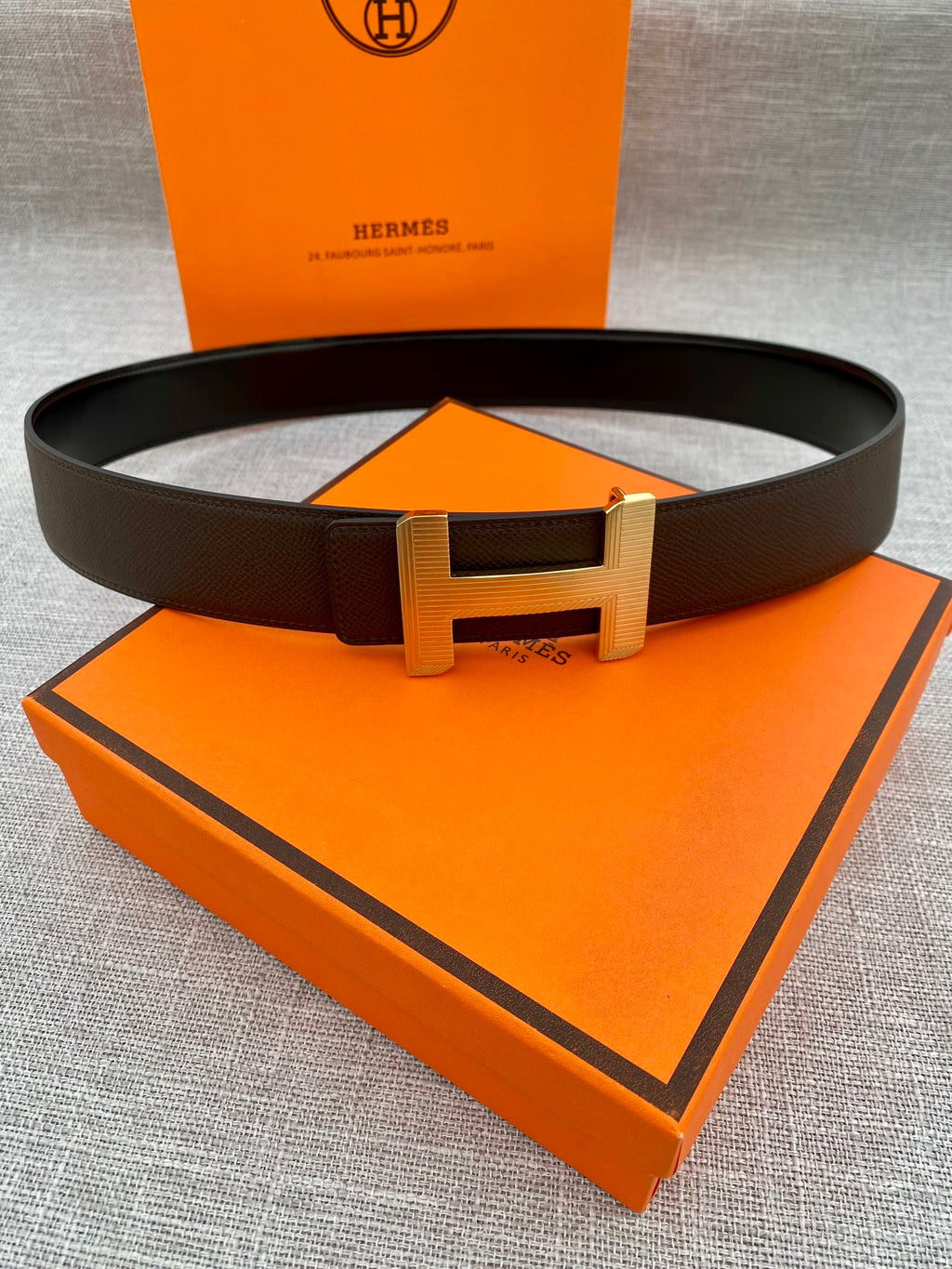 Hermes belt with dark leather strap and gold-tone H buckle