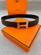 Hermes belt with dark leather strap and gold-tone H buckle