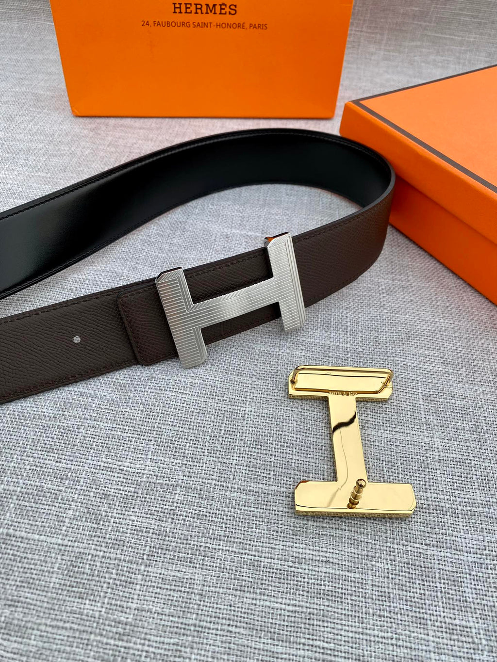 Hermes belt with dark leather strap and gold-tone H buckle