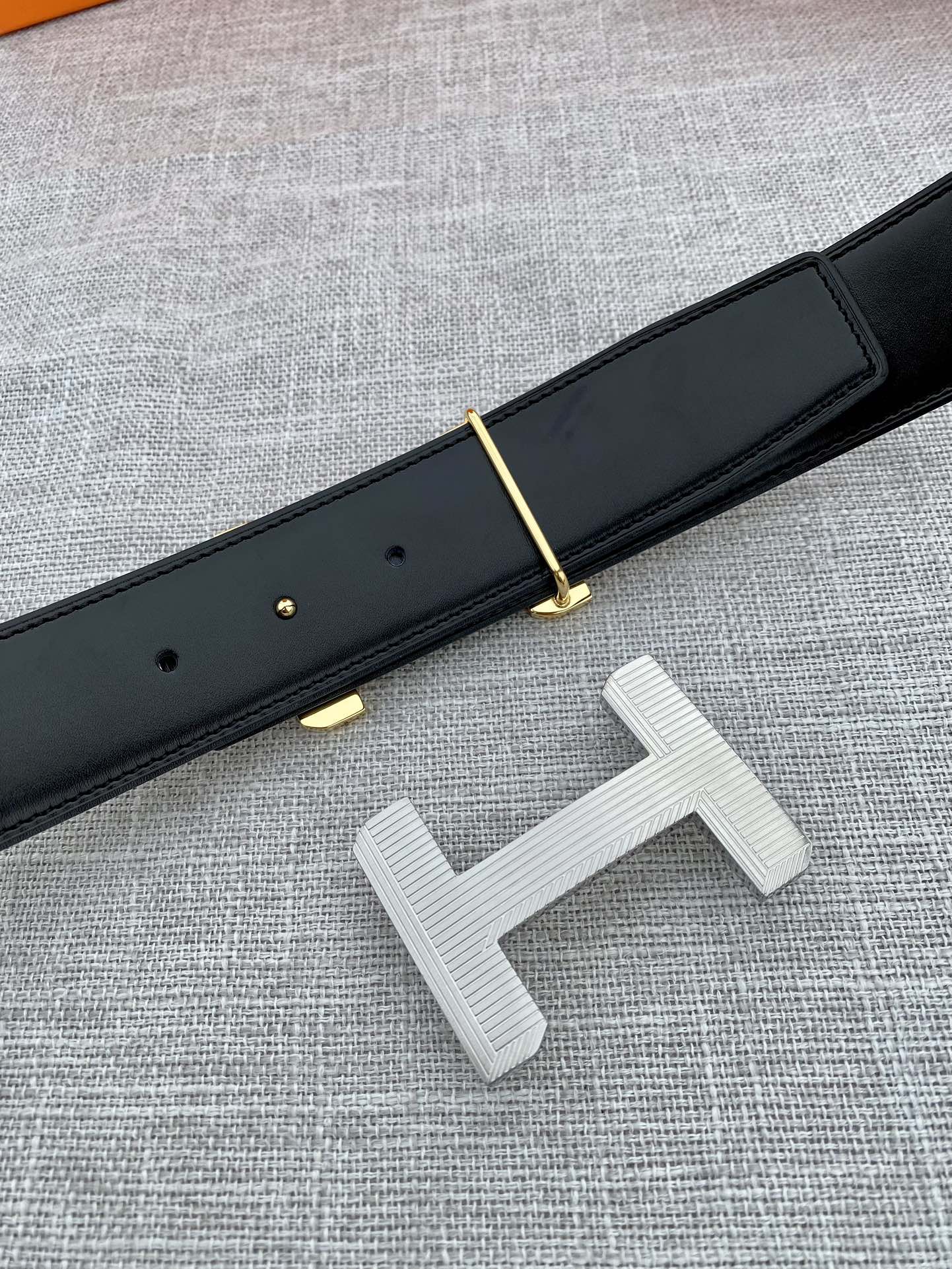 Hermes belt dark leather with gold-tone prong and silver-tone H buckle