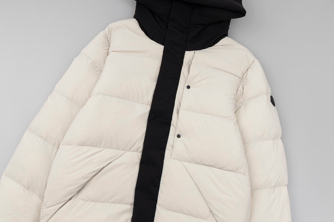 Long puffer jacket with hood, cream quilted panels, black placket and button front.