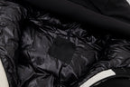 Black jacket lining with small fabric label and stitched seam detail.