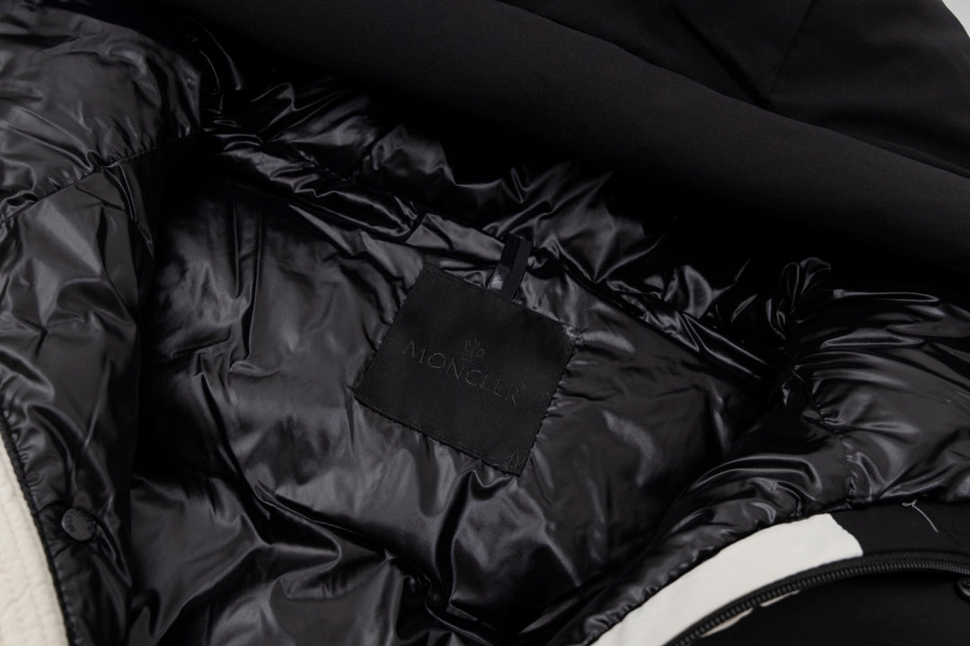 Black jacket lining with small fabric label and stitched seam detail.