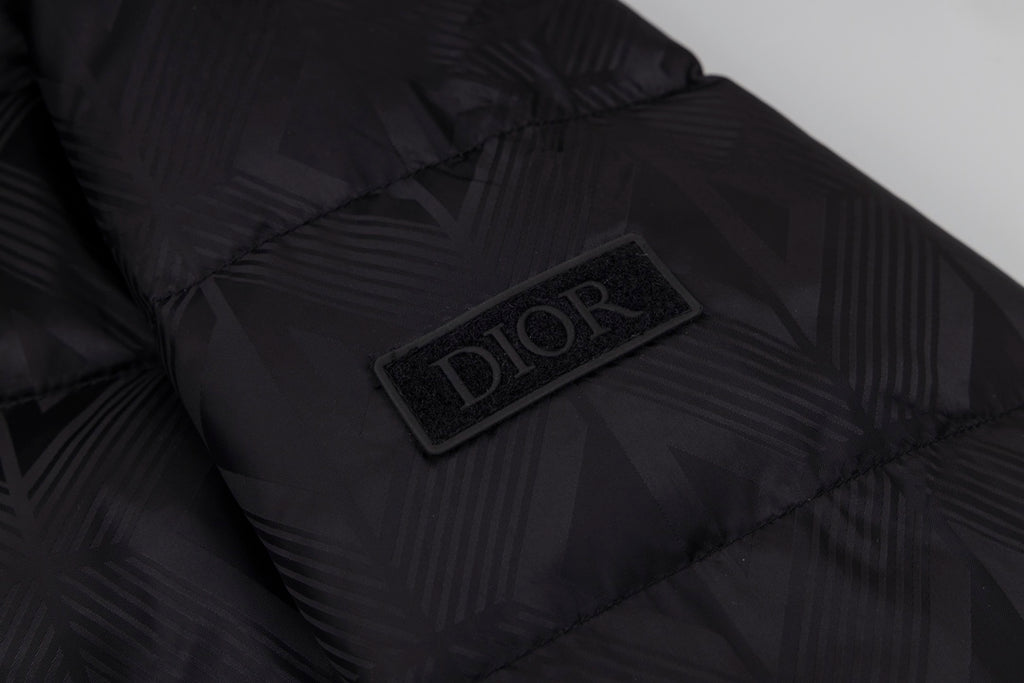 Black long puffer jacket interior patch with Dior logo.