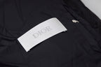 Black long puffer jacket with Dior logo fabric label on the chest.