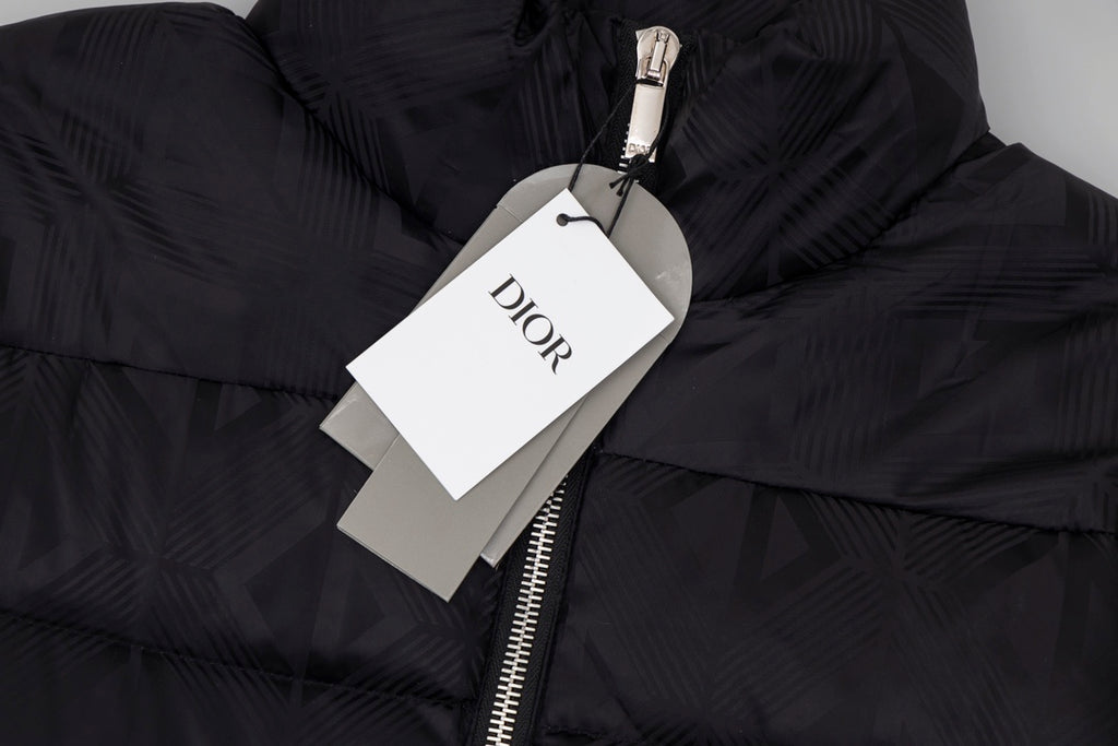 Black long puffer jacket detail with Dior hang tag and metal zipper pull.