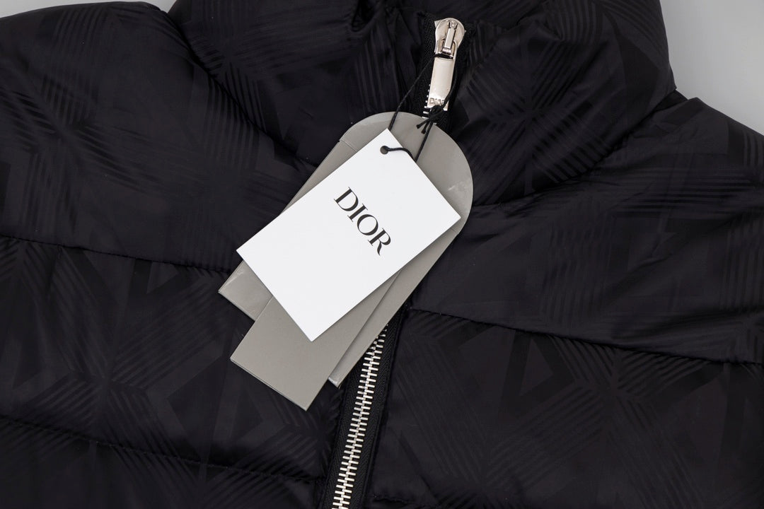 Black long puffer jacket detail with Dior hang tag and metal zipper pull.