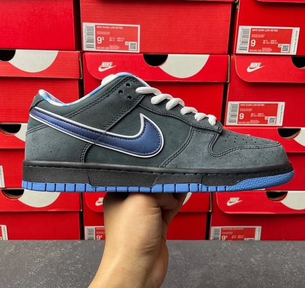 Nike SB Dunk Low sneakers, gray suede with blue swoosh stripe and white laces