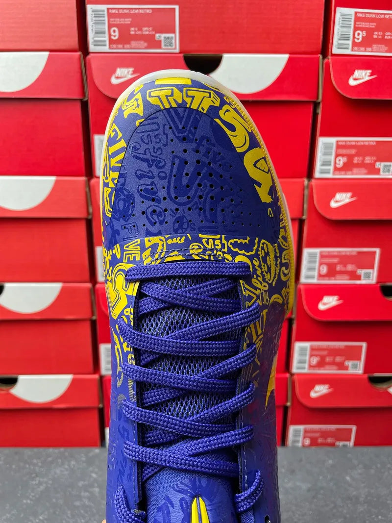 Blue basketball sneaker lace-up front with yellow graphic patterned toe box