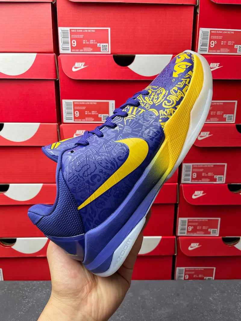 Blue basketball sneaker front-left view with yellow swoosh and lace-up upper