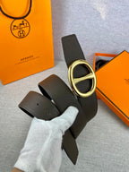 Dark leather belt with gold-tone double H buckle and matching strap.