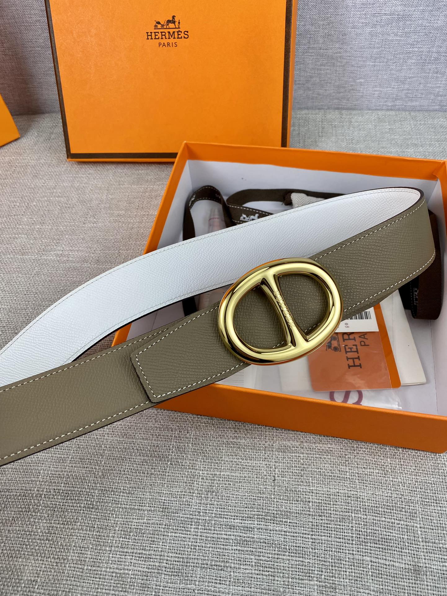 Olive leather belt with gold-tone double-ring buckle and white strap lining