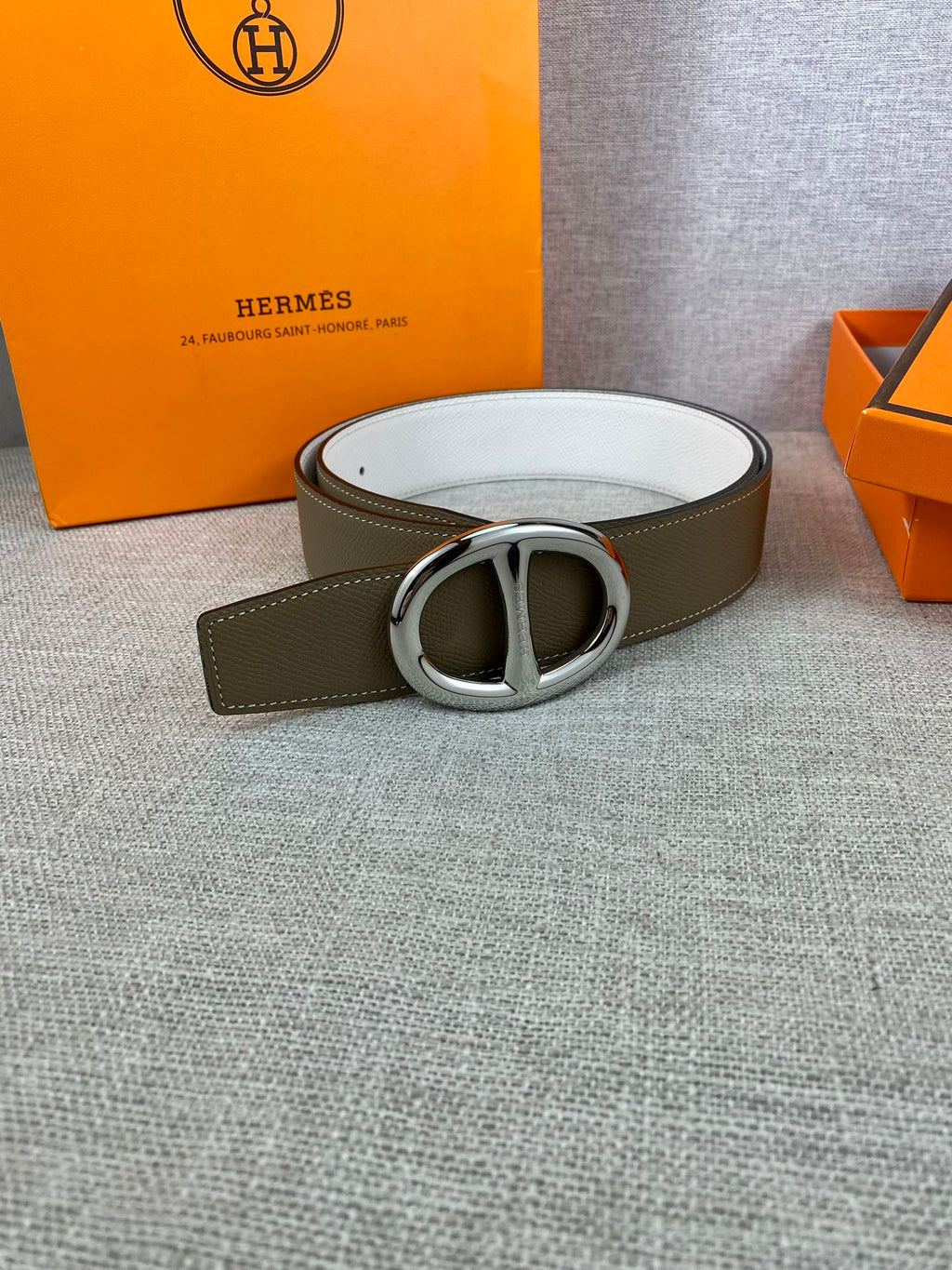 Olive leather belt with silver double-ring buckle and white underside