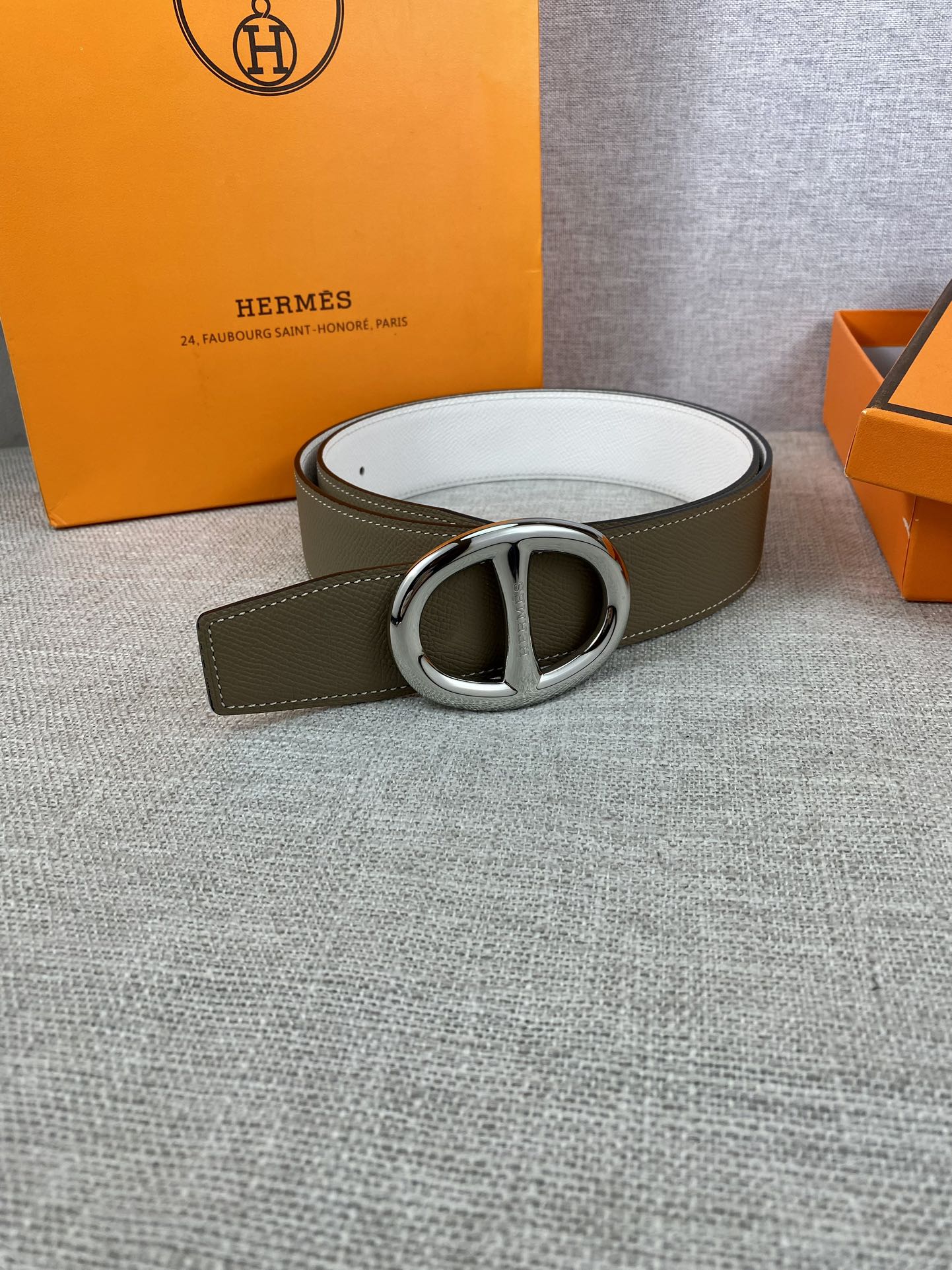 Olive leather belt with silver double-ring buckle and white underside