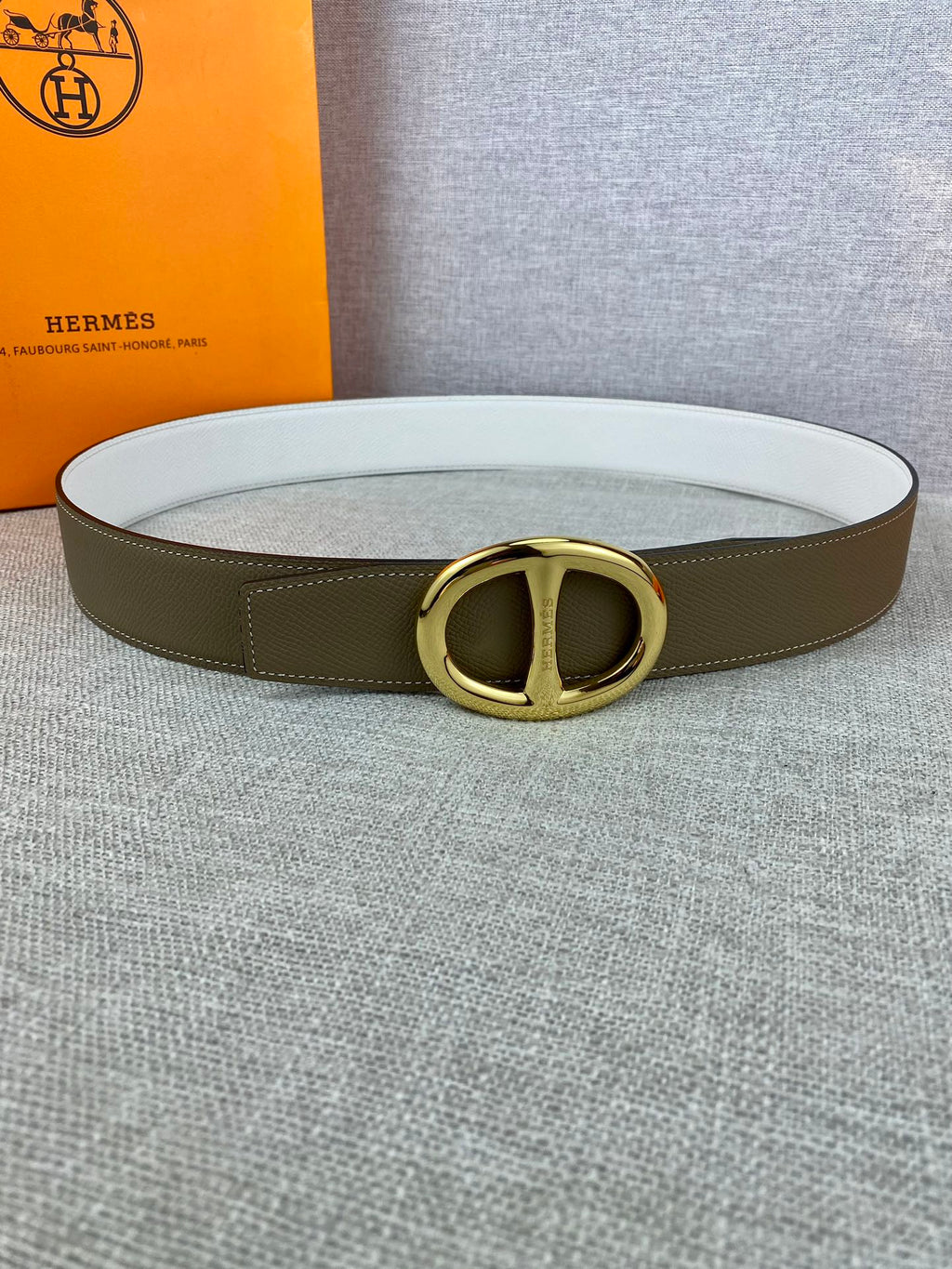 Olive leather belt with gold-tone double-ring buckle and white strap lining