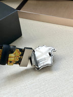 Versace belt close-up: dark blue leather end and baroque strap with Medusa buckle.