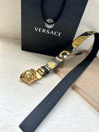 Versace belt detail: dark blue strap with baroque gold print and gold Medusa buckle.
