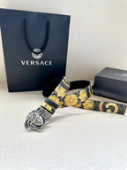 Versace belt with dark blue strap, baroque gold pattern, and silver-toned Medusa buckle.