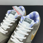 Grey sneaker pair with yellow swoosh, white laces, and blue patterned insoles