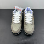 Pair of grey suede sneakers with white laces and perforated toe panels